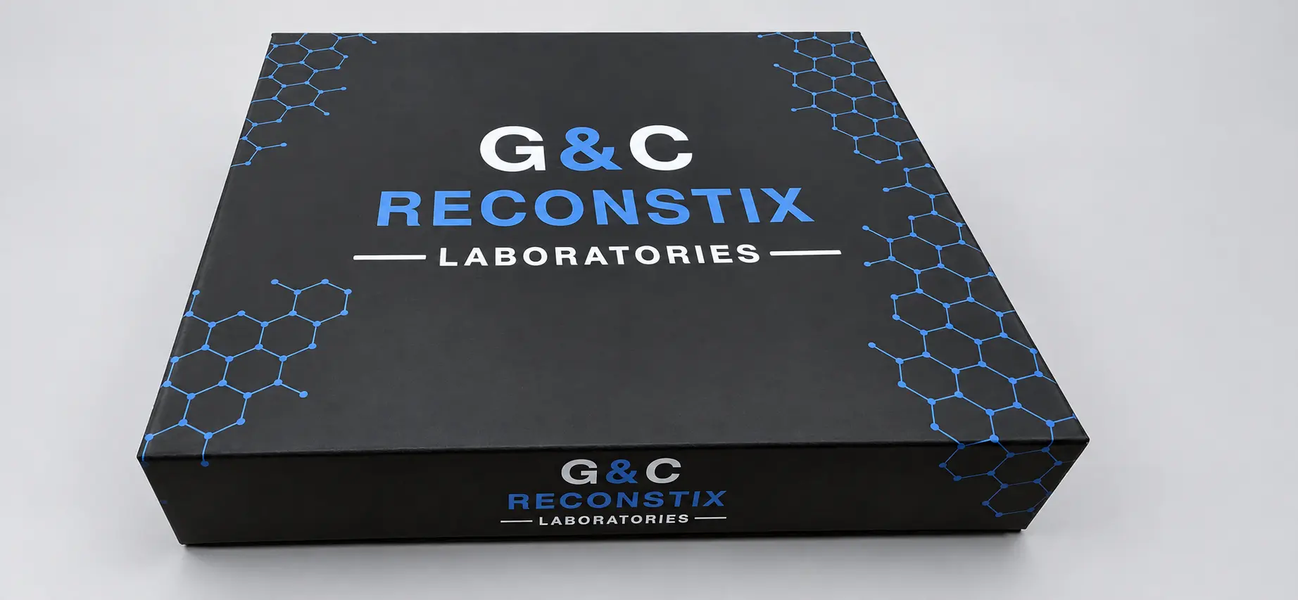 Closed black G&C Reconstix organizer box with blue molecular design